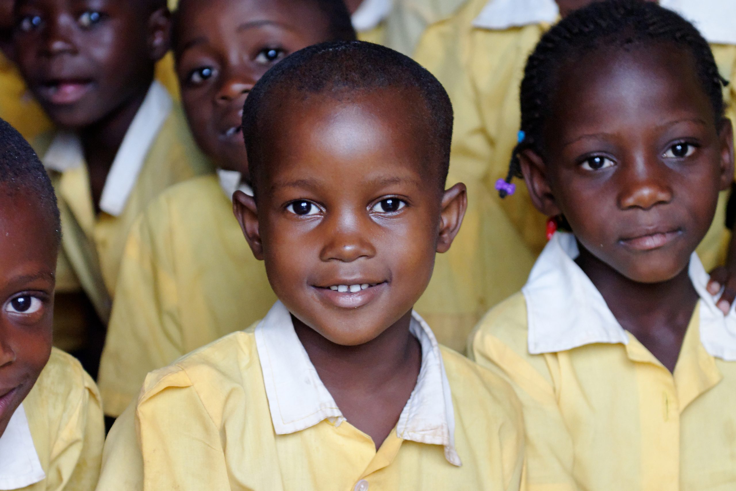 4x6-crop-Kyambadde-Allan---2019-2---Photo-students-Kanonko-School-Classroom-TA-Desk-_5853-- Humanitarian Sponsorship